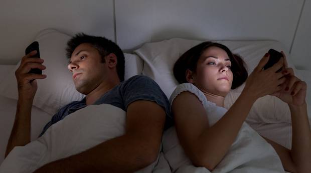 Couple disconnected in bed